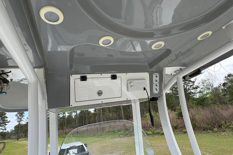 Slide: The Image of 2021 Sea Pro 259 DLX boat console with electronics and overhead lighting. - 8