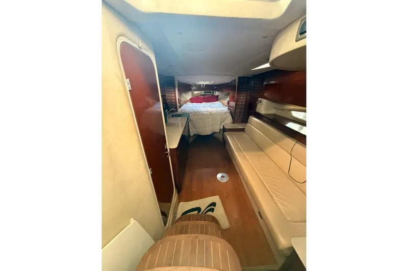 Slide: The Image of Interior of 2010 Sea Ray 370 Express Cruiser with cozy seating and bed. - 11