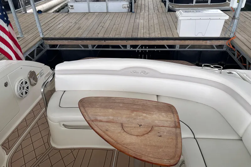 Slide: The Image of 2010 Sea Ray Sundancer 370 boat interior with wooden table and white seating. - 20