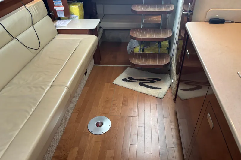 Slide: The Image of Interior of 2010 Sea Ray Sundancer 370 yacht with beige seating and wooden flooring. - 25