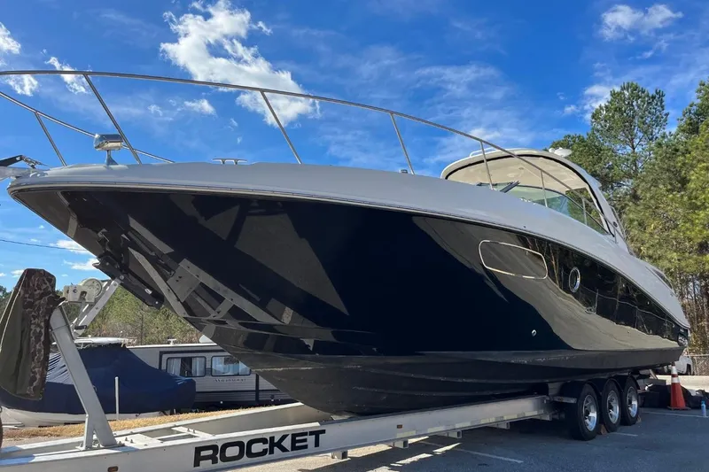 Slide: The Image of 2010 Sea Ray 370 Express Cruiser on trailer under clear blue sky. - 5