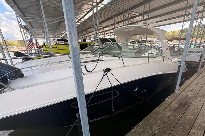 Slide: The Image of 2010 Sea Ray 370 Express Cruiser docked in a covered marina. - 7