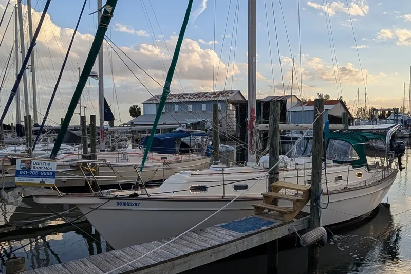 Slide: The Image of 1998 Island Packet 40 sailboat docked at marina during sunset. - 3