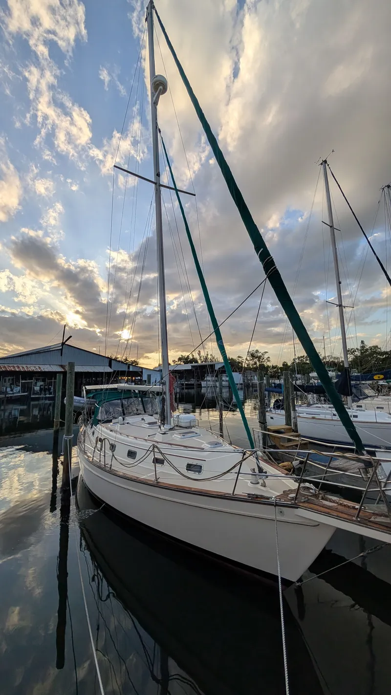 Slide: The Image of 1998 Island Packet 40 sailboat docked at sunset. - 4