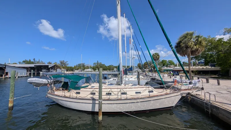 Slide: The Image of 1998 Island Packet 40 sailboat docked in harbor on a sunny day. - 5
