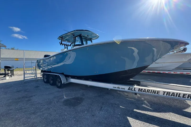 The Image of 2026 Tidewater 302 CC Adventure boat on trailer under sunny sky. - 0