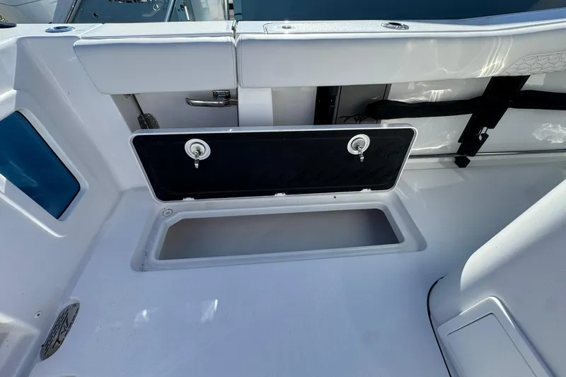 Slide: The Image of 2026 Tidewater 302 CC Adventure boat storage compartment, open and ready for use. - 10