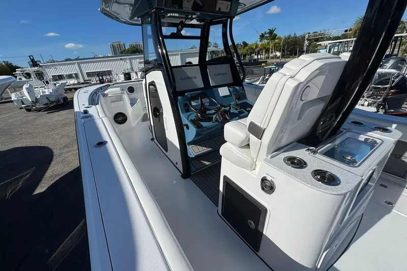 Slide: The Image of 2026 Tidewater 302 CC Adventure boat interior with helm, seating, and Garmin electronics. - 13