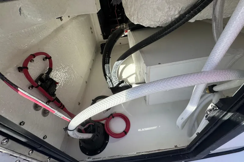 Slide: The Image of Interior view of 2026 Tidewater 302 CC Adventure boat showing wiring and components. - 16