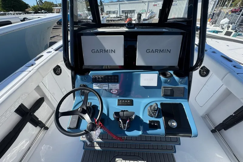 Slide: The Image of 2026 Tidewater 302 CC Adventure boat dashboard with dual Garmin displays and Yamaha controls. - 21