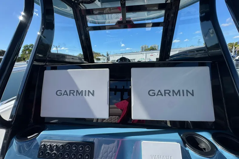 Slide: The Image of Dual Garmin displays on 2026 Tidewater 302 CC Adventure boat dashboard. - 22