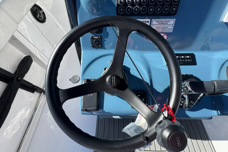 Slide: The Image of Steering wheel of 2026 Tidewater 302 CC Adventure boat, featuring modern controls. - 27