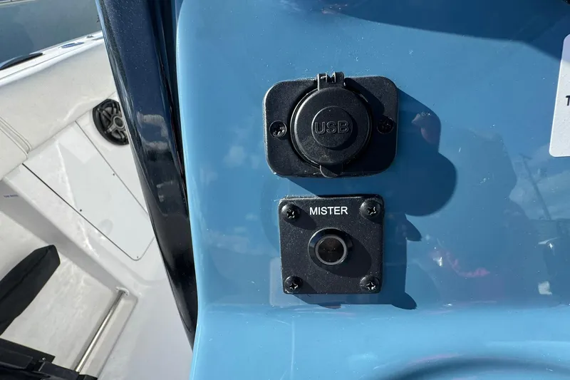 Slide: The Image of USB and mister ports on 2026 Tidewater 302 CC Adventure boat dashboard. - 28