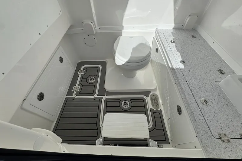 Slide: The Image of 2026 Tidewater 302 CC Adventure boat interior with toilet and storage compartments. - 34