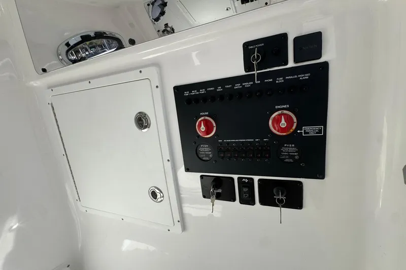 Slide: The Image of Control panel of 2026 Tidewater 302 CC Adventure boat with switches and keys. - 36