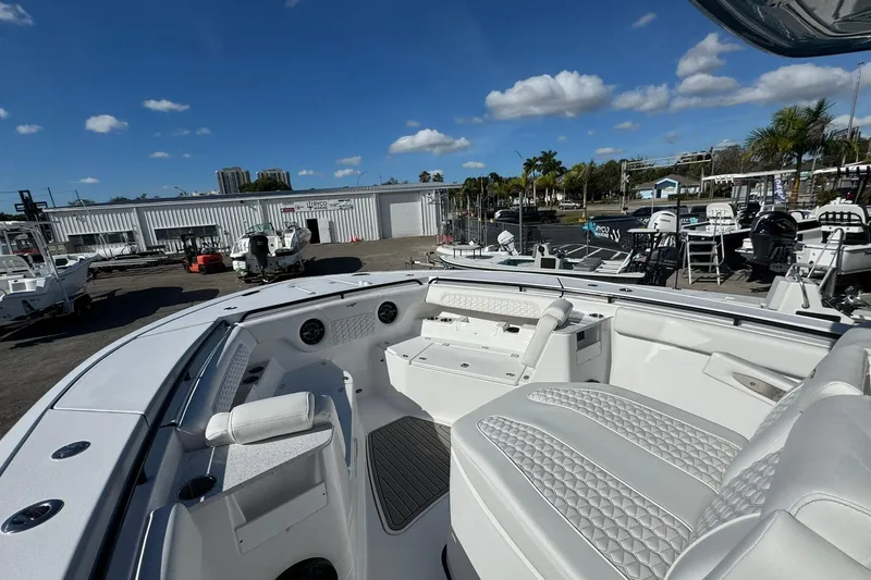 Slide: The Image of 2026 Tidewater 302 CC Adventure boat interior with luxurious seating and clear blue sky. - 38