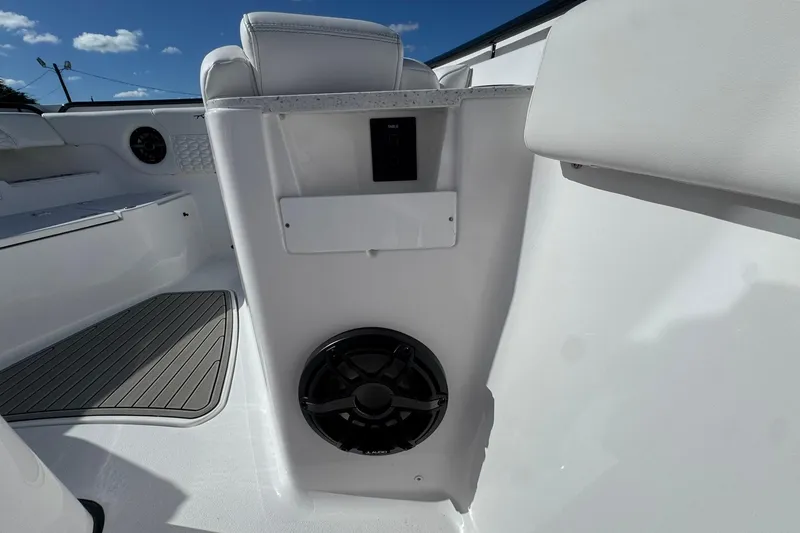 Slide: The Image of Interior view of 2026 Tidewater 302 CC Adventure boat, featuring seating and speaker system. - 41