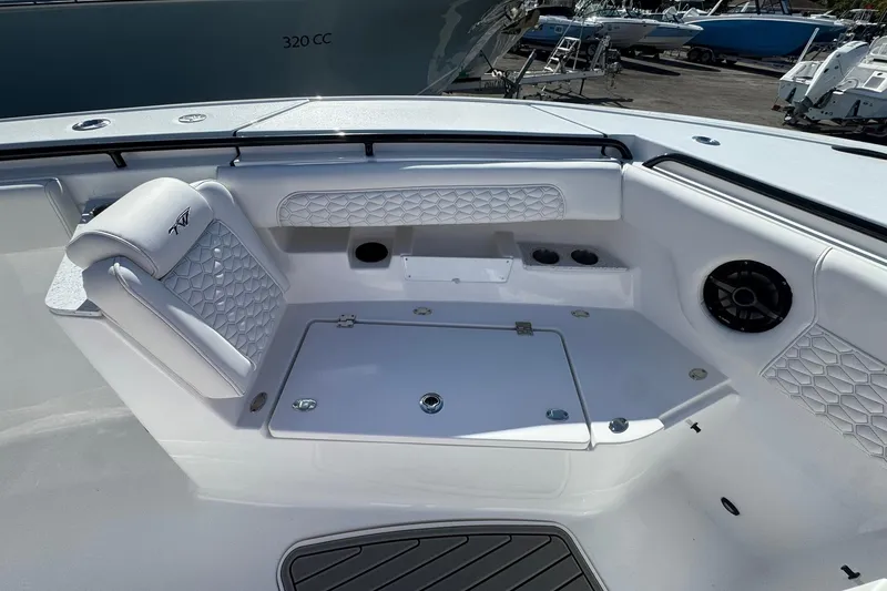 Slide: The Image of 2026 Tidewater 302 CC Adventure boat interior with cushioned seating and storage compartments. - 42