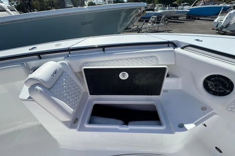 Slide: The Image of 2026 Tidewater 302 CC Adventure boat interior with seating and storage compartment. - 43