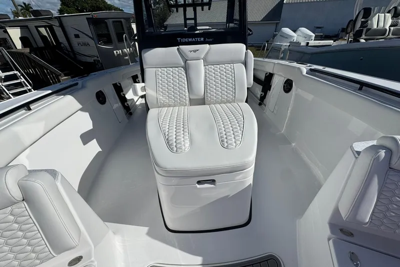 Slide: The Image of 2026 Tidewater 302 CC Adventure boat interior with white cushioned seating. - 44