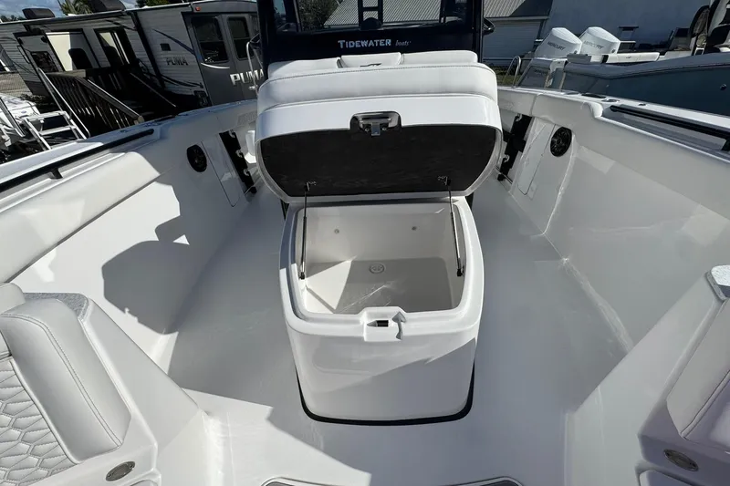 Slide: The Image of 2026 Tidewater 302 CC Adventure boat with open storage compartment on deck. - 45