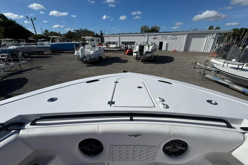 Slide: The Image of 2026 Tidewater 302 CC Adventure boat in a marina with clear skies. - 46