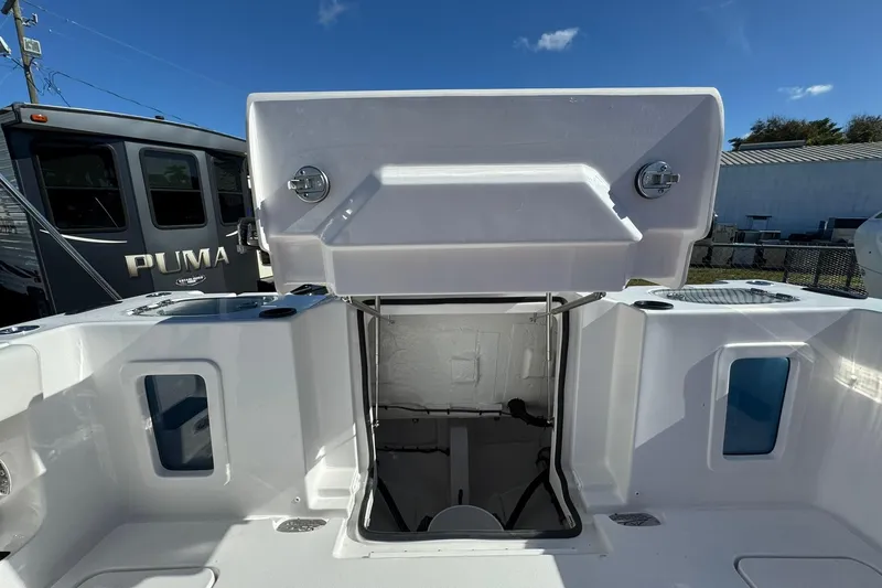 Slide: The Image of 2026 Tidewater 302 CC Adventure boat interior with open storage compartment. - 6
