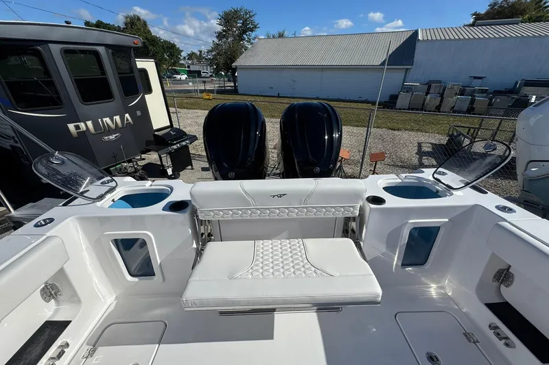 Slide: The Image of 2026 Tidewater 302 CC Adventure boat interior with dual engines and seating area. - 8