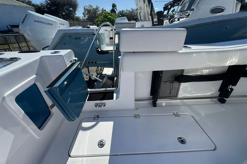 Slide: The Image of 2026 Tidewater 302 CC Adventure boat interior with open hatch and seating area. - 9