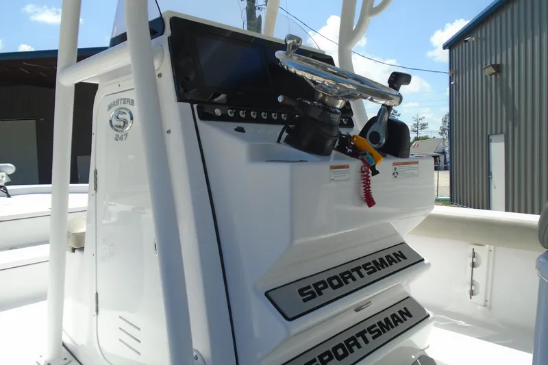 Slide: The Image of 2021 Sportsman Masters 247 Bay Boat console with steering wheel and controls. - 11