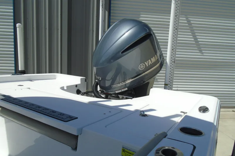 Slide: The Image of 2021 Sportsman Masters 247 Bay Boat with Yamaha outboard motor in a storage facility. - 13