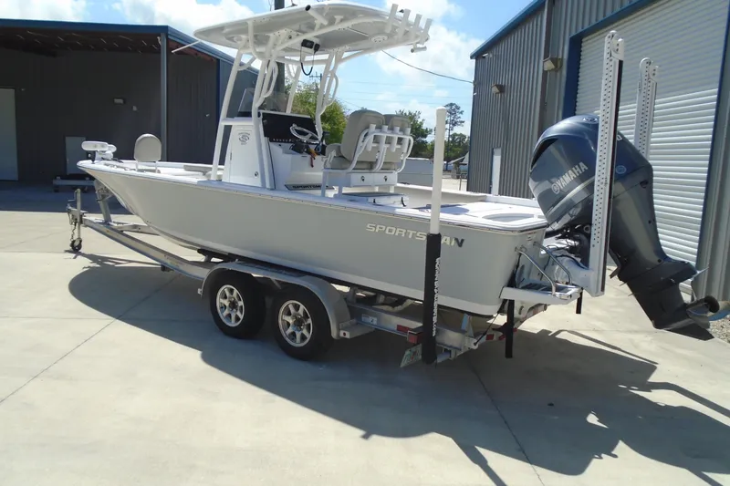 Slide: The Image of 2021 Sportsman Masters 247 Bay Boat on trailer, parked outside a warehouse. - 14