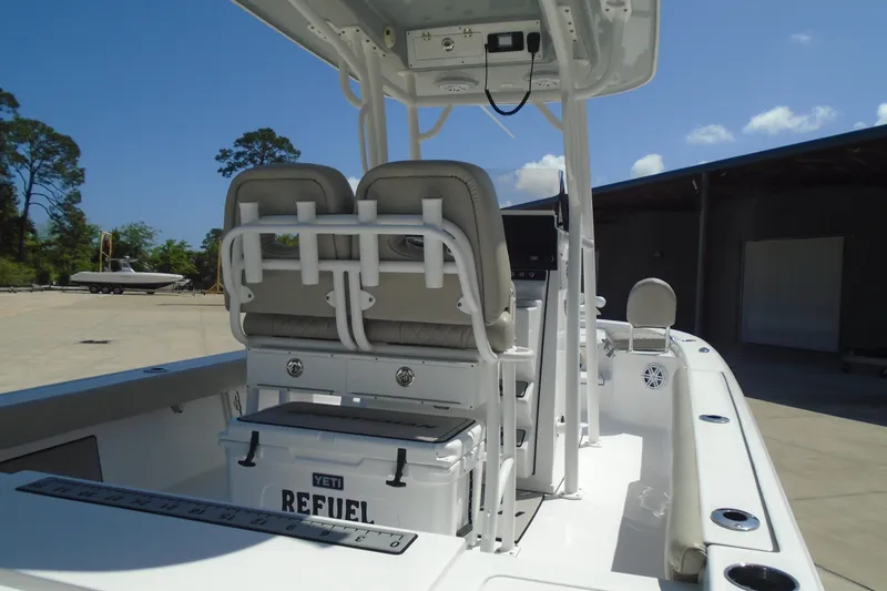 Slide: The Image of 2021 Sportsman Masters 247 Bay Boat interior with dual seats and Yeti cooler. - 16