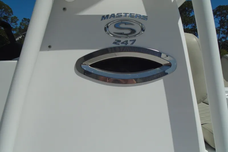 Slide: The Image of 2021 Sportsman Masters 247 Bay Boat console with logo and emblem detail. - 3