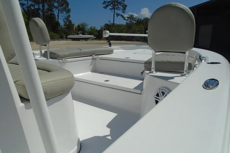 Slide: The Image of 2021 Sportsman Masters 247 Bay Boat interior with cushioned seating and storage compartments. - 5