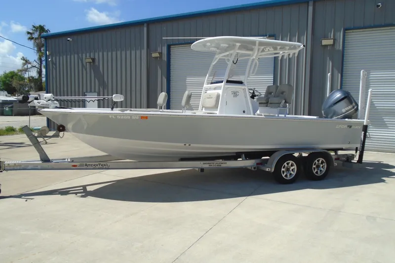 Slide: The Image of 2021 Sportsman Masters 247 Bay Boat on trailer, parked outside industrial building. - 8