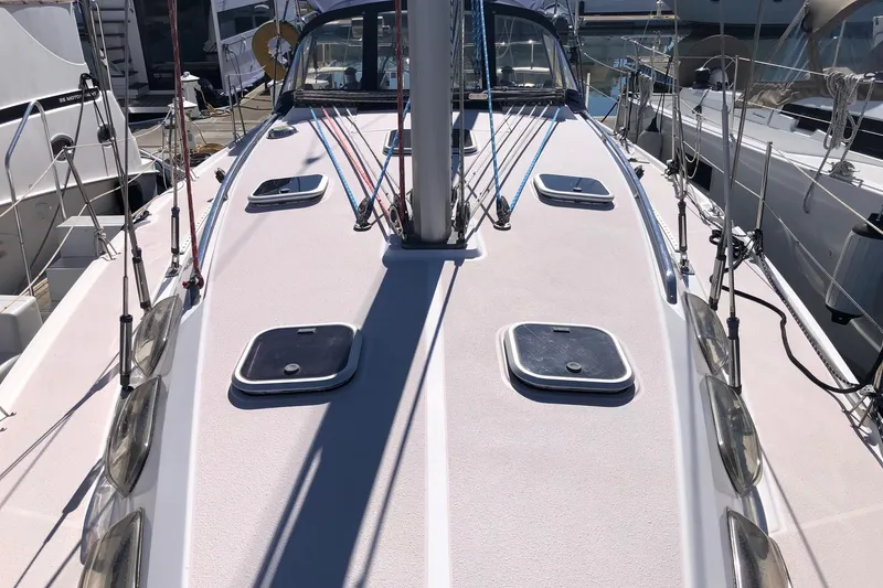 Slide: The Image of Deck view of a 1998 Catalina 380 sailboat, featuring hatches and rigging. - 12