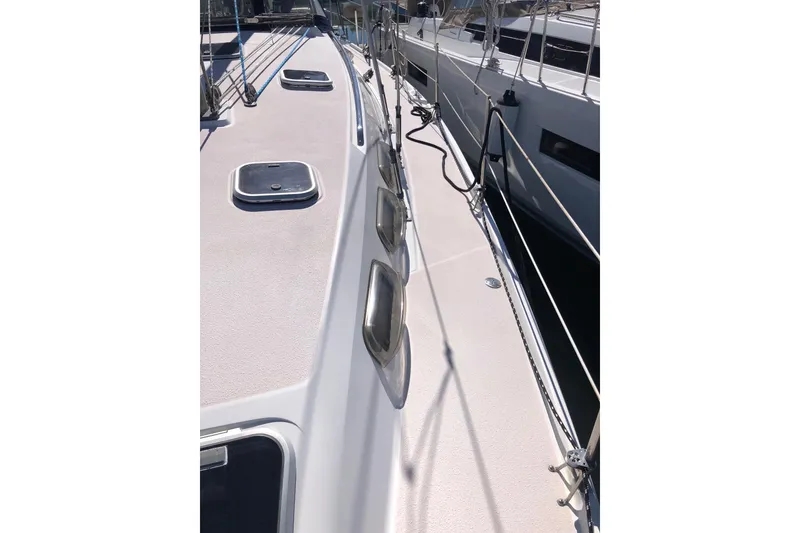 Slide: The Image of Deck view of a 1998 Catalina 380 sailboat, showcasing hatches and rigging. - 14