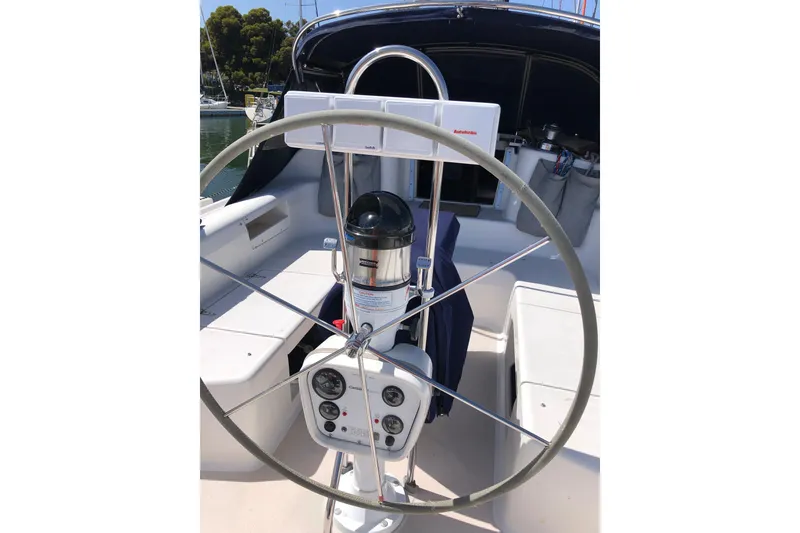 Slide: The Image of Cockpit of 1998 Catalina 380 sailboat with steering wheel and navigation instruments. - 16