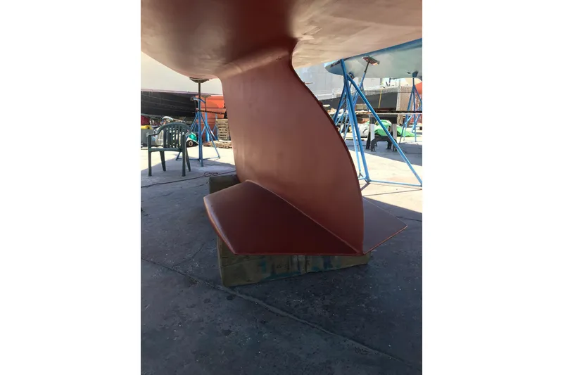 Slide: The Image of Catalina 380 sailboat keel and rudder, 1998 model, in a boatyard setting. - 18