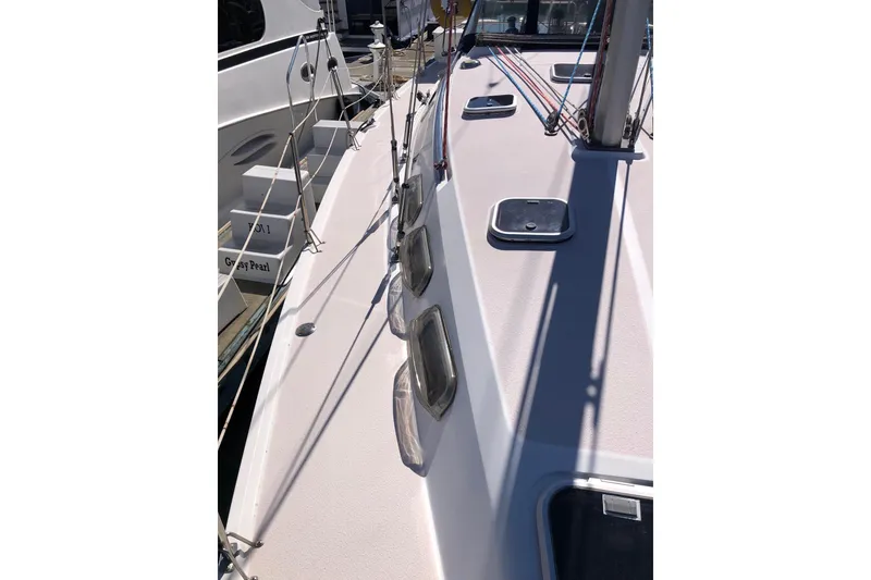 Slide: The Image of 1998 Catalina 380 sailboat deck with rigging and hatches in marina. - 2