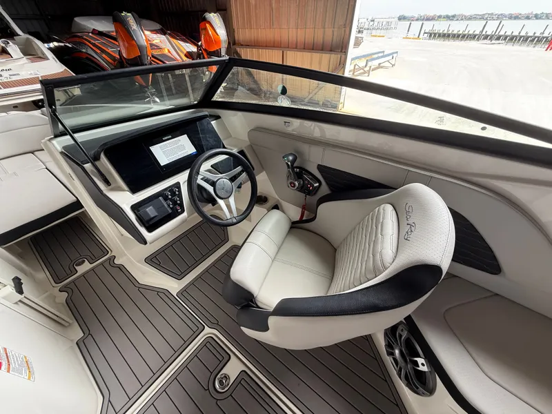 Slide: The Image of Interior of 2023 Sea Ray 23 SPX OB with helm console. - 12