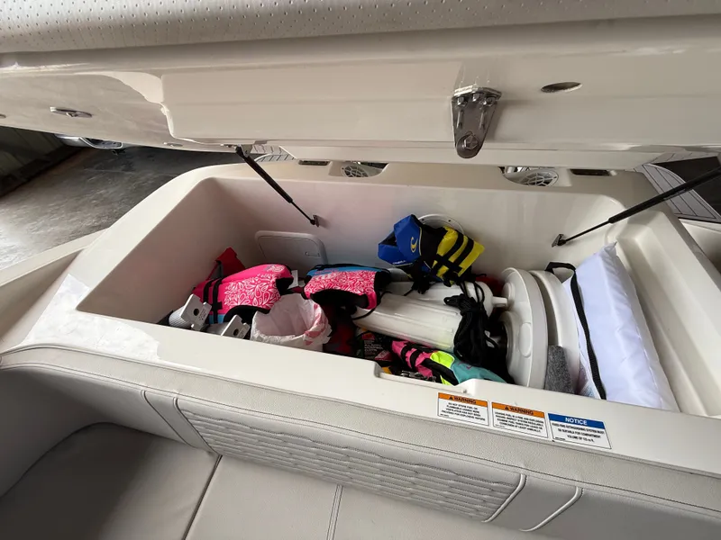 Slide: The Image of Storage compartment in Sea Ray 23 SPX OB boat with life jackets. - 18