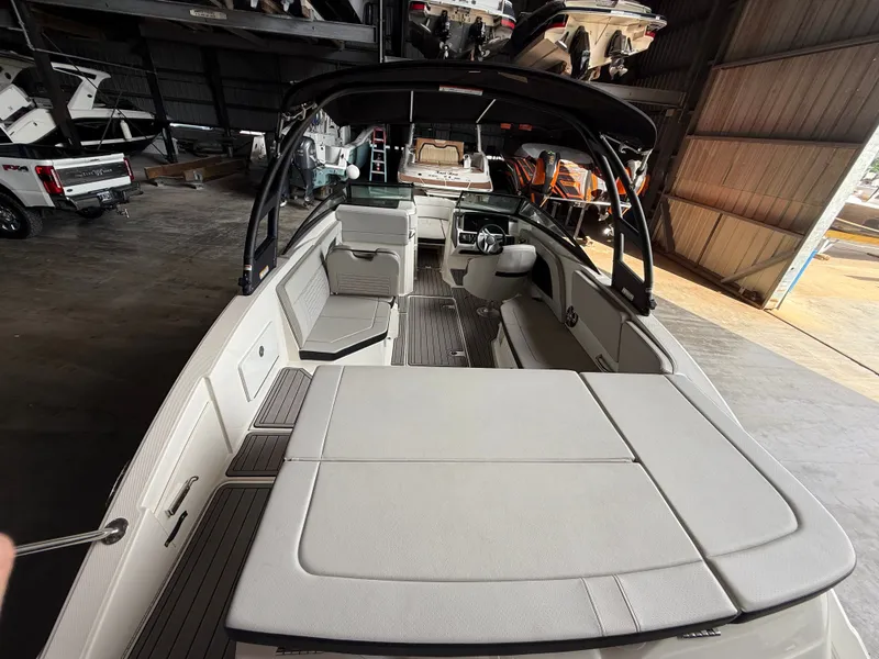 Slide: The Image of Interior view of a 2023 Sea Ray 23 SPX OB boat in a storage facility. - 21