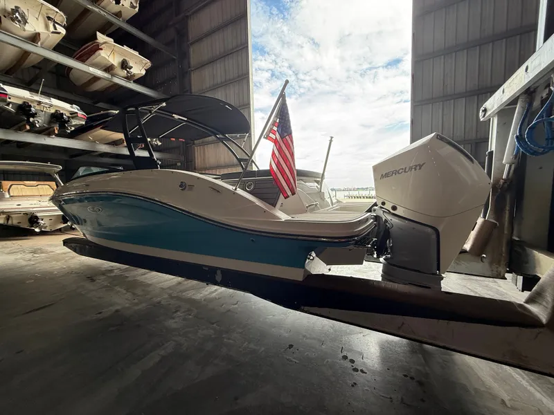 Slide: The Image of 2023 Sea Ray 23 SPX OB boat in storage with US flag. - 3