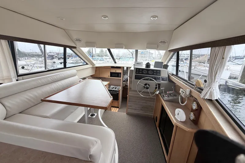 Slide: The Image of Interior of 2000 Bayliner 3388 Command Bridge Motoryacht with helm and seating area. - 5