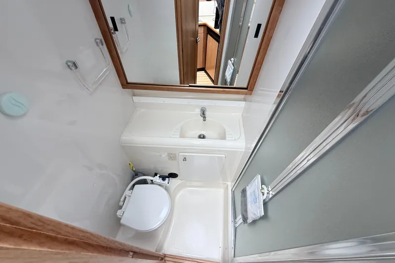Slide: The Image of Bathroom interior of 2000 Bayliner 3388 Command Bridge Motoryacht with sink and toilet. - 7