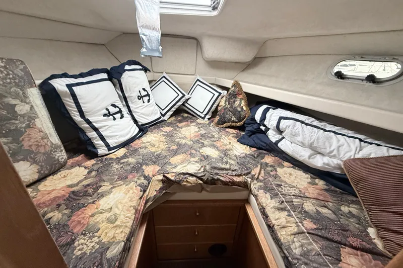 Slide: The Image of Cozy cabin interior of 2000 Bayliner 3388 Command Bridge Motoryacht with floral bedding and nautical pillows. - 8