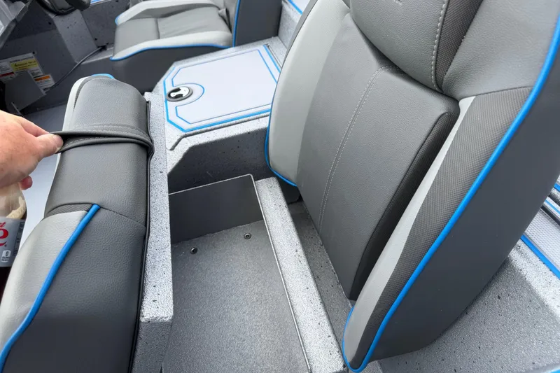 Slide: The Image of 2026 Xpress H20 boat interior with gray and blue seating and storage compartment. - 6