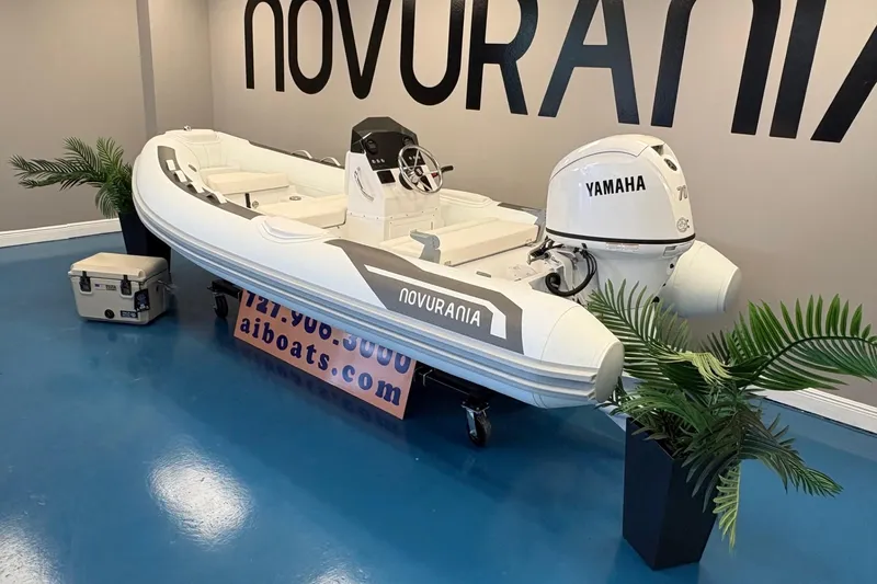 Slide: The Image of 2026 Novurania DL 430 boat with Yamaha engine displayed indoors. - 2